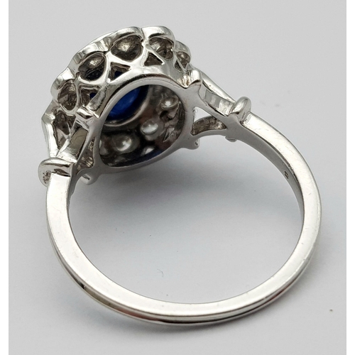 82 - A STUNNING 18K WHITE GOLD DIAMOND & SAPPHIRE CLUSTER RING, WITH APPROX 0.50CT DARK BLUE SAPPHIRE CEN... 