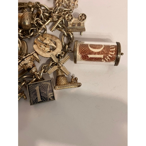 982 - Vintage SILVER CHARM BRACELET Having an interesting selection of charms dating from the 1920’s to th... 