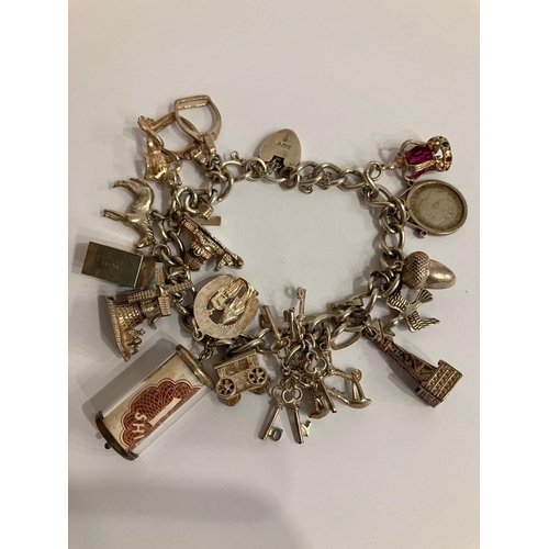 982 - Vintage SILVER CHARM BRACELET Having an interesting selection of charms dating from the 1920’s to th... 