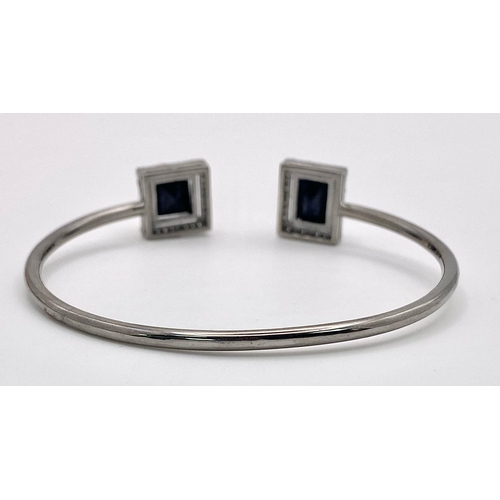 1216 - A Blue Sapphire and Diamond Cuff Bracelet.  Blue Sapphire- 10.85ctw. Diamonds- 0.50ctw. Set in 925 s... 