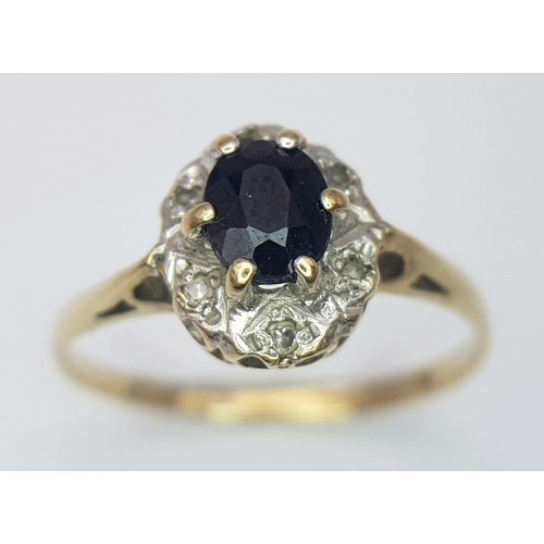 289 - A vintage 9 K yellow gold ring with an oval cut, dark blue sapphire surrounded by old cut diamonds, ... 