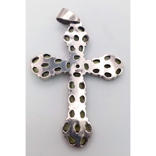 683 - A Sterling Silver and Peridot Set Cross Pendant 7.5cm Length. Set with 38 Peridots the Cross Measure... 