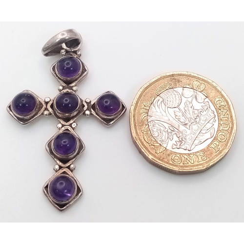 844 - A Sterling Silver Amethyst Cabochon Cross Pendant. 4.5cm Length. Set with 4mm Round Cut Amethyst Cab... 