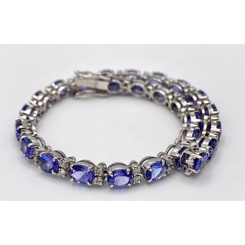 213 - A spectacular 18 K white gold bracelet with oval cut tanzanite gems and round cut diamonds. Length: ... 