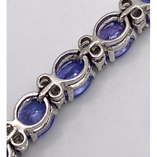 213 - A spectacular 18 K white gold bracelet with oval cut tanzanite gems and round cut diamonds. Length: ... 