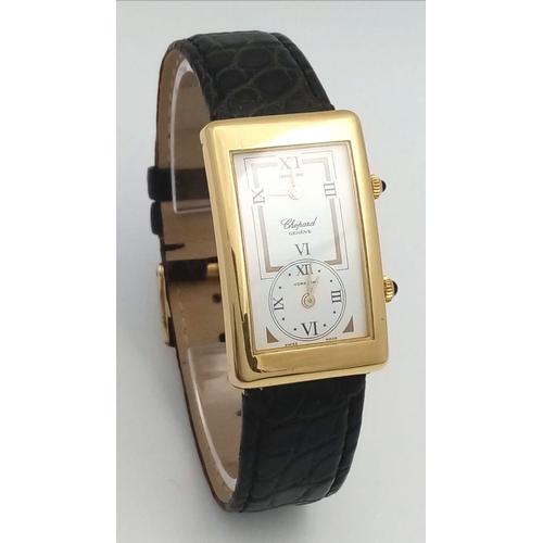 102 - A Chopard 18K Gold Home Time (Dual Time) Gents Watch. Black leather strap. 18K gold rectangular case... 