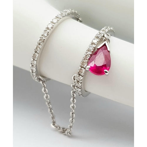 222 - A 14K WHITE GOLD DIAMOND & RUBY SET FINGER CHAIN RING, WEIGHT 2.5G SIZE H