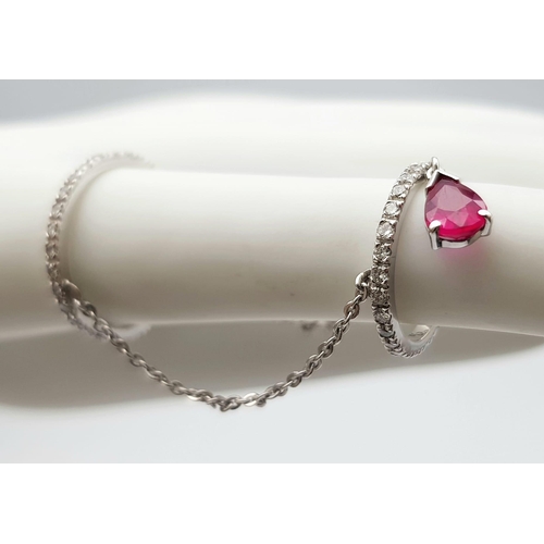 222 - A 14K WHITE GOLD DIAMOND & RUBY SET FINGER CHAIN RING, WEIGHT 2.5G SIZE H