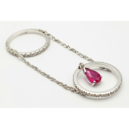 222 - A 14K WHITE GOLD DIAMOND & RUBY SET FINGER CHAIN RING, WEIGHT 2.5G SIZE H