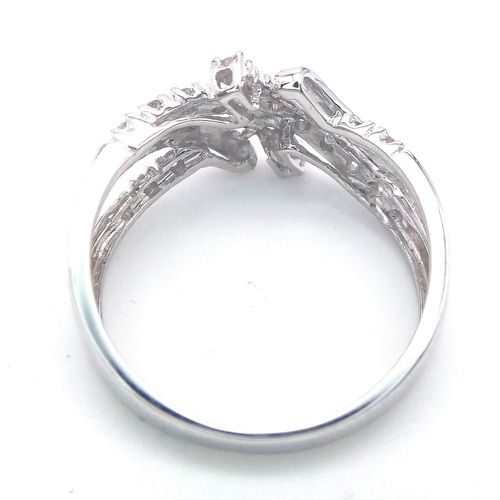 495 - A FANCY 9K WHITE GOLD DIAMOND CROSSOVER RING, APPROX 0.15CT DIAMONDS, WEIGHT 2.6G SIZE Q