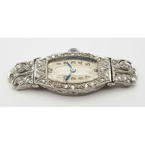 572 - A FABULOUS ART DECO PLATINUM AND DIAMOND WATCH(OVERWOUND) .