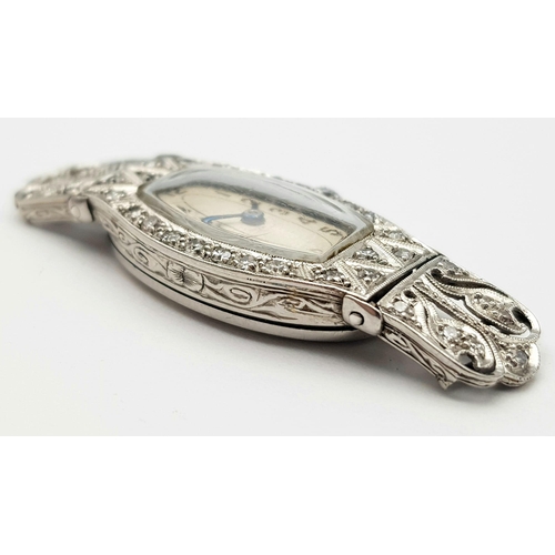 572 - A FABULOUS ART DECO PLATINUM AND DIAMOND WATCH(OVERWOUND) .