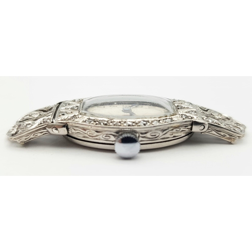 572 - A FABULOUS ART DECO PLATINUM AND DIAMOND WATCH(OVERWOUND) .