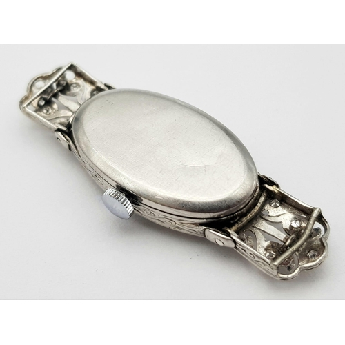 572 - A FABULOUS ART DECO PLATINUM AND DIAMOND WATCH(OVERWOUND) .