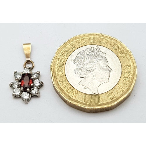 600 - A DIAMOND AND GARNET PENDANT SET IN 14K GOLD .   .7gms