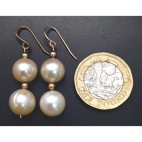 956 - A pair of fresh water pearl earrings. One earring appears to have a 14 K yellow gold hook. earrings ... 