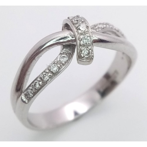 180 - A FANCY 18K WHITE GOLD DIAMOND KNOTTED RING, APPROX 0.15CT DIAMONDS, WEIGHT 3.8G SIZE N