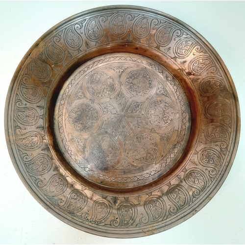 1033 - A QAJAR HAND DECORATED COPPER DISH .   28cms DIAMETER