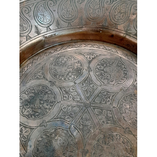 1033 - A QAJAR HAND DECORATED COPPER DISH .   28cms DIAMETER