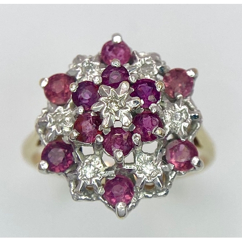 545 - AN ATTRACTIVE 9K YELLOW GOLD DIAMOND & RUBY CLUSTER RING, WEIGHT 3.5G SIZE O