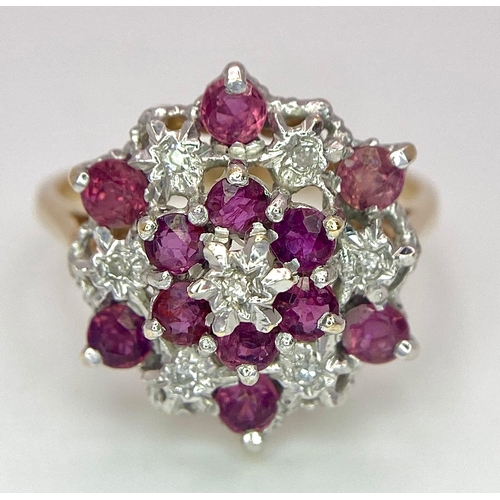 545 - AN ATTRACTIVE 9K YELLOW GOLD DIAMOND & RUBY CLUSTER RING, WEIGHT 3.5G SIZE O