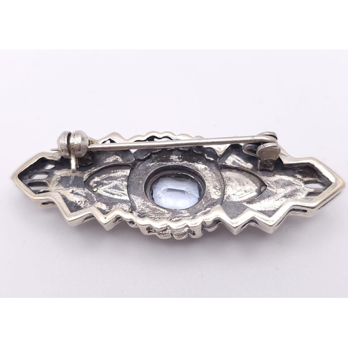 691 - An Exquisite Design Sterling Silver and Topaz Art Deco style Brooch. 5cm Wide. Gross Weight 8.88 Gra... 