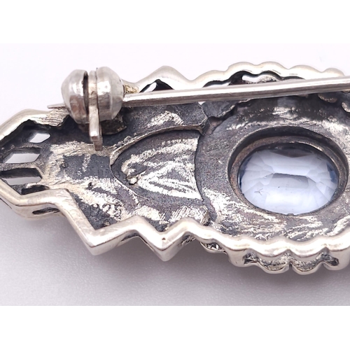 691 - An Exquisite Design Sterling Silver and Topaz Art Deco style Brooch. 5cm Wide. Gross Weight 8.88 Gra... 