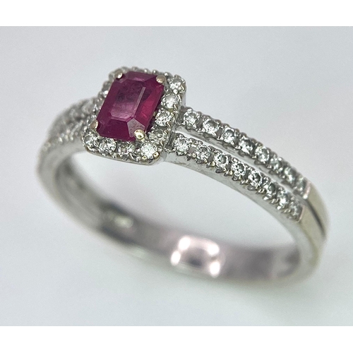 509 - 18K WHITE GOLD DIAMOND & RUBY RING, WITH A RECTANGULAR 0.30CT RUBY AND DECORATED BY A HALO DIAMONDS ... 