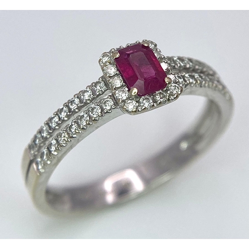 509 - 18K WHITE GOLD DIAMOND & RUBY RING, WITH A RECTANGULAR 0.30CT RUBY AND DECORATED BY A HALO DIAMONDS ... 