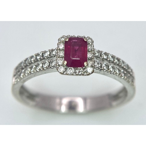 509 - 18K WHITE GOLD DIAMOND & RUBY RING, WITH A RECTANGULAR 0.30CT RUBY AND DECORATED BY A HALO DIAMONDS ... 