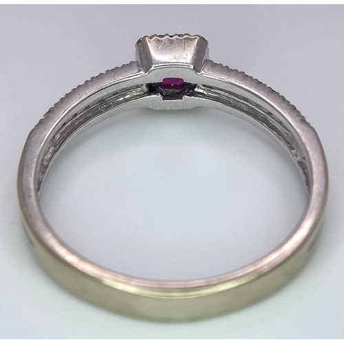 509 - 18K WHITE GOLD DIAMOND & RUBY RING, WITH A RECTANGULAR 0.30CT RUBY AND DECORATED BY A HALO DIAMONDS ... 