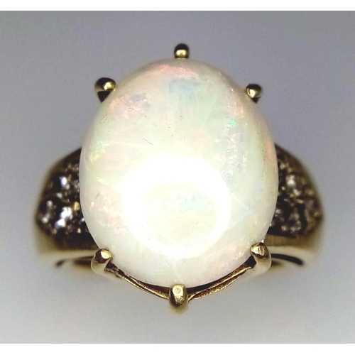 1067 - A LARGE FIRE OPAL RING FLANKED BY DIAMOND SHOULDERS SET IN 9K GOLD .    9.5gms   size N