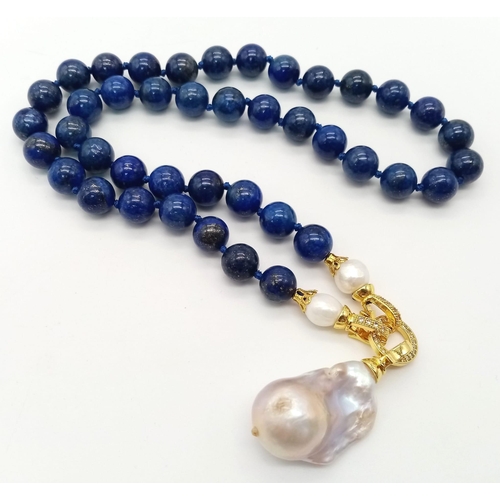 627 - A Keisha Baroque Pearl Pendant on a Lapis Lazuli Beaded Necklace. 5cm gilded pendant with white ston... 