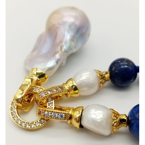 627 - A Keisha Baroque Pearl Pendant on a Lapis Lazuli Beaded Necklace. 5cm gilded pendant with white ston... 