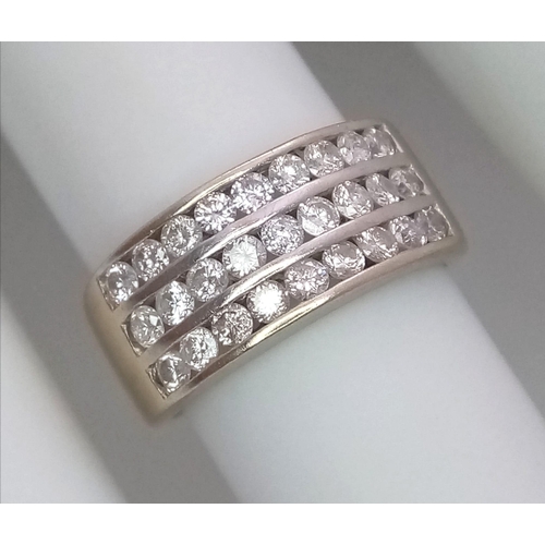 747 - A well made 18 K yellow gold ring with three channels filled with round cut diamonds. Size: H, weigh... 