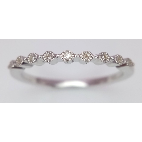 754 - A sterling silver ring with a band of round cut cubic zirconia. Size: N1/2, weight: 1.5 g.