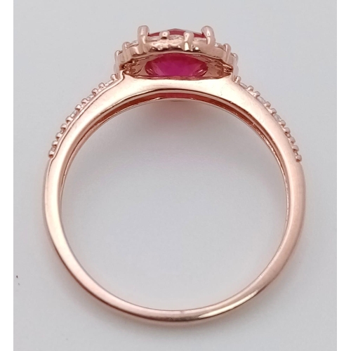 808 - A sterling silver and rose gold plated ring with a simulated ruby surrounded by cubic zirconia. Size... 