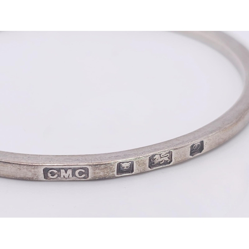 885 - A vintage sterling silver bangle with full London hallmarks, 1978. Total weight 20.7G. Diameter 7cm.