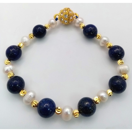 1071 - A Lapis Lazuli and Cultured Pearl Bracelet. Gilded spacers and magnetic glitterball clasp.