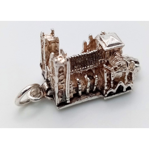 1077 - STERLING SILVER WESTMINSTER ABBEY CHARM WHICH OPENS TO REVEAL A BIBLE, WEIGHT 6G