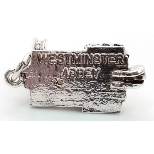 1077 - STERLING SILVER WESTMINSTER ABBEY CHARM WHICH OPENS TO REVEAL A BIBLE, WEIGHT 6G