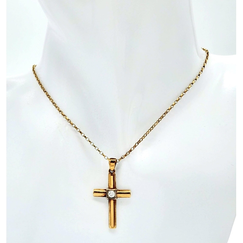 656 - A 9 K yellow cross with a single round cut diamond on a 41 cm long 9 K gold chain. Cross dimensions:... 