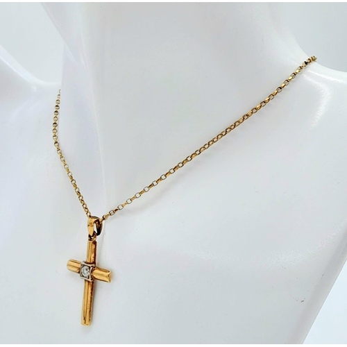 656 - A 9 K yellow cross with a single round cut diamond on a 41 cm long 9 K gold chain. Cross dimensions:... 