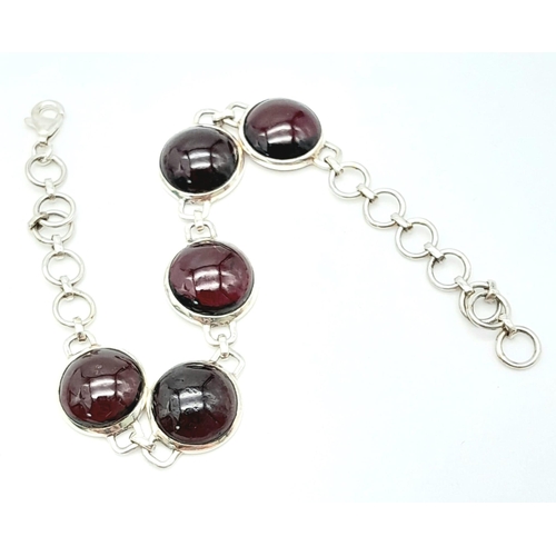 802 - A Sterling Silver Red Stone Cabochon Set Bracelet. 19cm Length. 1.3cm Width. Gross Weight 12.75 Gram... 