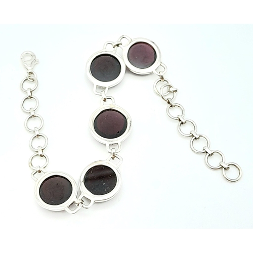 802 - A Sterling Silver Red Stone Cabochon Set Bracelet. 19cm Length. 1.3cm Width. Gross Weight 12.75 Gram... 