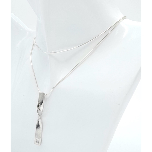 913 - A stylist 925 silver CZ pendant on sparkling Italy silver chain. Total weight 8.85G. Total length 62... 