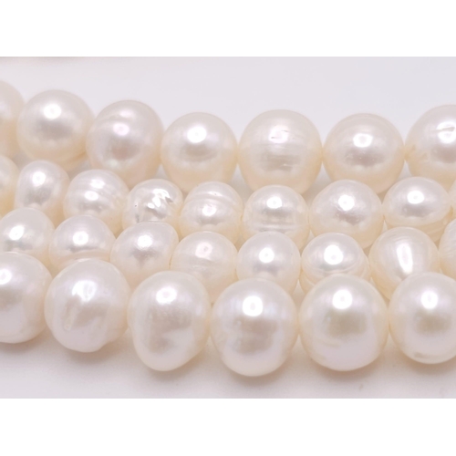 592 - A Two Row Cultured Pearl Necklace with Sterling Silver and White Stone Clasp. 80cm length.