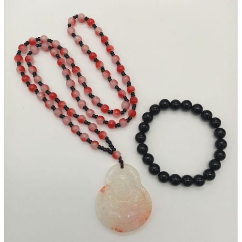 822 - A Chinese Budha carved agate pendant on a necklace with red and pink beads. Necklace length: 63 cm, ... 