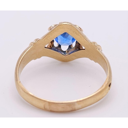 974 - An 18K Yellow Gold and Blue Topaz Ring. Stunning central oval cut topaz. Size P. 3.5g total weight.