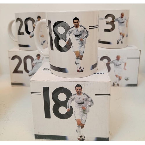 606 - A Collection of Eleven Real Madrid Mugs - Each decorated with a different player. As new, in boxes. ... 